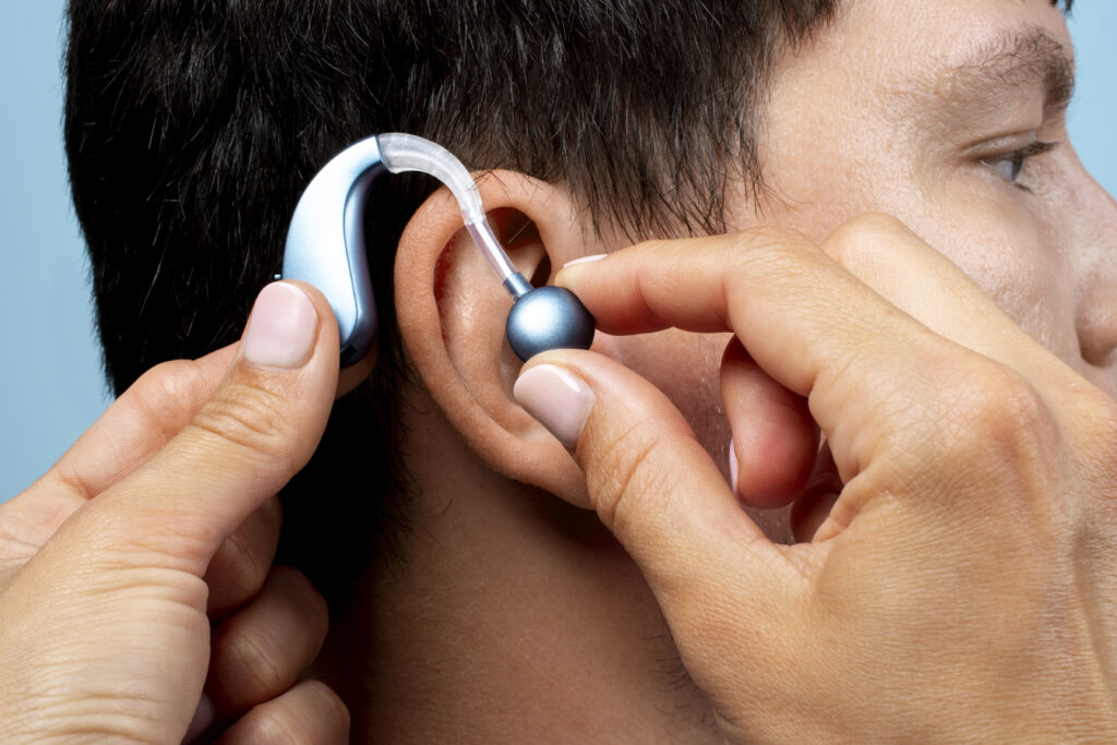 man wearing hearing aids side view man wearing hearing aids side view